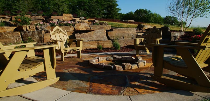 Patio with fire pit and natural boulder wall